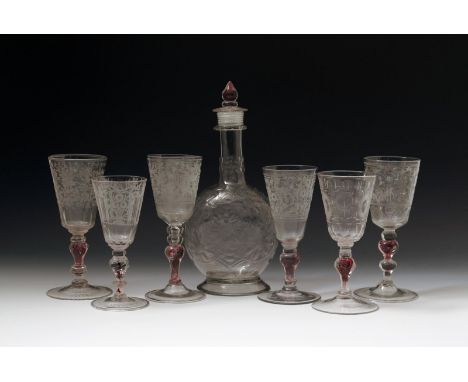 Six Bohemian glass colour twist goblets, 18th century, the flared bowls variously engraved with birds and flowers amidst form