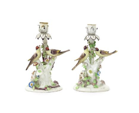 Two Bow candlestick groups of goldfinches, c.1760, each modelled with two birds perched on branches entwined with flowering t