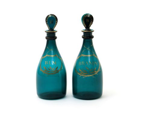 A pair of green glass decanters and stoppers, c.1800, of mallet form, gilded with chained labels titled 'Rum' and 'Brandy', t