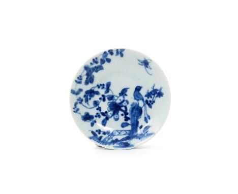 A miniature Worcester blue and white saucer, c.1755-60, painted with the Rock Warbler pattern, a long-tailed bird perched on 