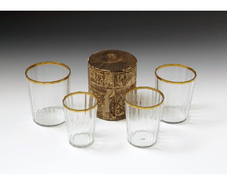 A Continental boxed nest of four graduated glass beakers, 18th century, the glasses vertically fluted and of slightly flared 