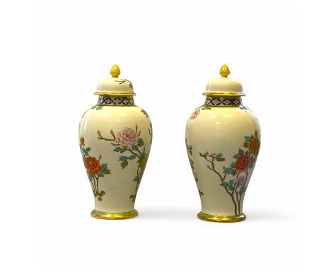 A pair of Noritake lidded vases, 12cm diameter, 26cm tall (small chip to inside rim of one cover otherwise good condition)