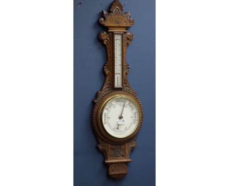 Early 20th century heavily carved oak case aneroid barometer with mercury thermometer, H90cm   Condition Report   Click here 