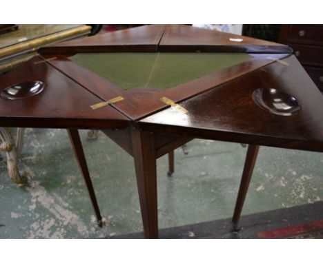 An Edwardian mahogany envelope card table, crossbanded top opening to a baize playing surface and cups, single drawer to frie