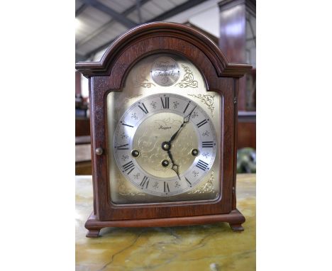 A mahogany cased three keyhole mantel clock