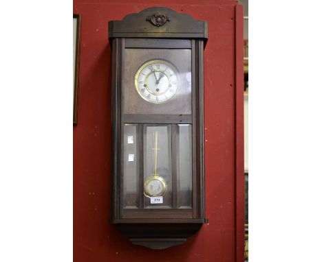 A 1940's mahogany wall clock case with modern movement 