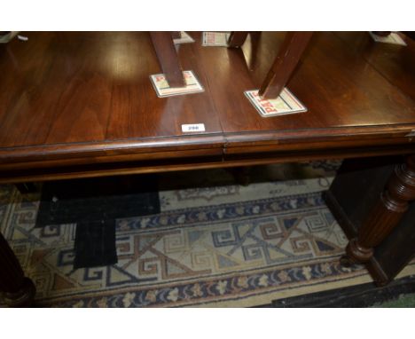 A Victorian mahogany windout dining table, rectangular top, canted angles, moulded edge, turned and reeded legs, ceramic cast