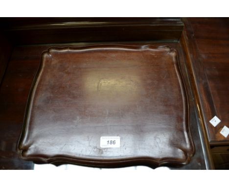 A Chinese hardwood shaped rectangular serving tray, dished border, shallow scroll feet, 35cm wide, c.1900
