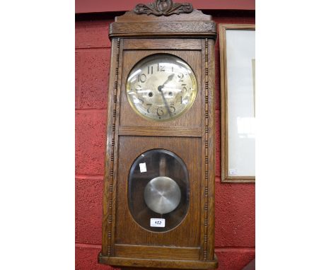 A 1940's oak wall clock 