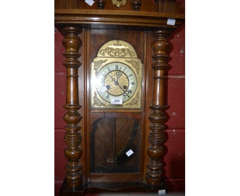 A mahogany Vienna wall clock, Roman numerals, carved pediment