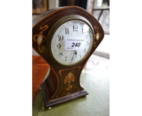 A mahogany inlaid Art Nouveau mantel clock