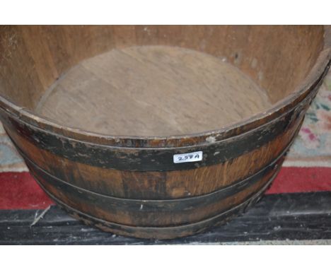 An oak planter made from a coopered barrel.