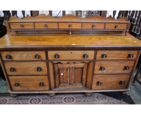 A Victorian light mahogany and pine sideboard, shaped gallery and five small drawers to superstructure, oversailing top, sing