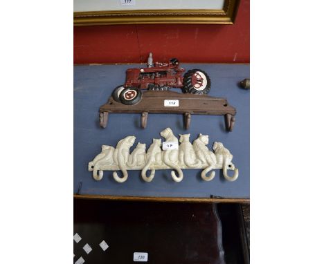 Cast metal coat racks, one with tractor, the other as a row of cats. (2)