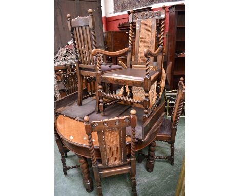 An oak wind out dining table, circular top, gadrooned border, barley twist legs; three oak dining chairs, carved top rail, ba