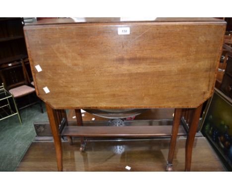 An Edwardian mahogany Sutherland table, cross banded top, canted angles, ceramic casters