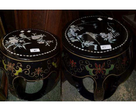 A pair of Chinese lacquered barrel shaped mother of pearl inlaid stools (2)