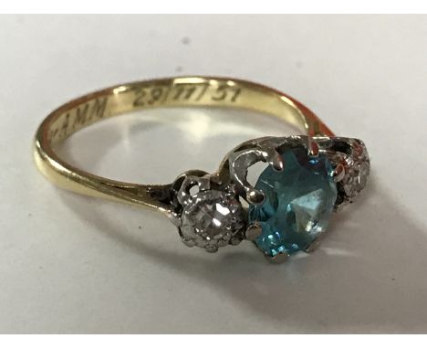 An 18ct gold blue zircon and diamond three stone ring, size L. CONDITION REPORT: The zircon has some abrasions to the facets 