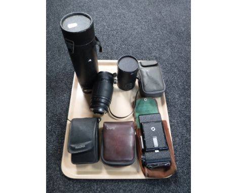 A tray of four cameras including Helina, Kodak, camera lenses, two in cases