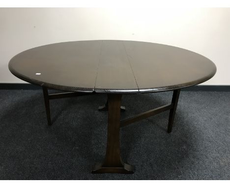 A narrow Ercol elm drop leaf table 