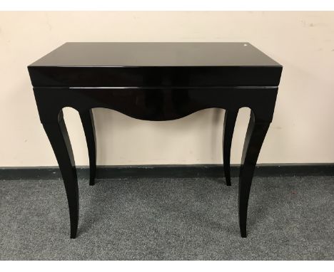 A contemporary black console table, width 80 cm