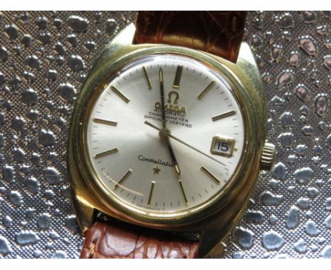 Omega constellation automatic Chronometer   wristwatch with date, gold plated case on leather strap with omega buckle. Case b