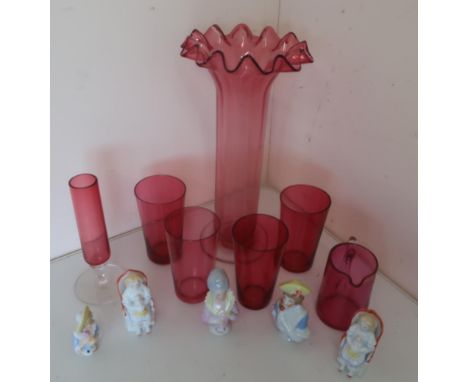 Ruby glass vase with frilled top and clear stem, four ruby glass tumblers, a jug with clear handle, three pin cushion dolls a