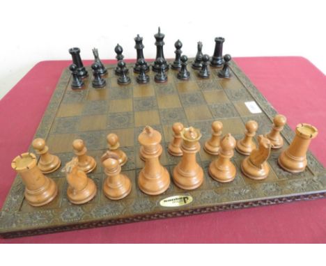 Large turned boxwood and ebonized chess set, on John Jaques chess board with alternate carved rose decoration  (king H11cm) 