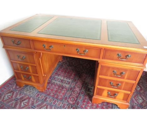 Geo. lll style yew twin pedestal desk with inset gilt tooled leather top on bracket feet. (W137cm x  D76cm x H78cm) 