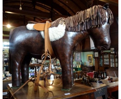 A 20th century stuffed leather child's stool, probably by Omersa for Liberty, in the form of a pony, 67 x 94cm.