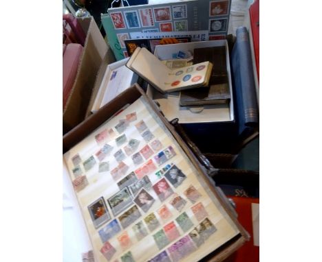 A box containing stamp collectors information catalogues and other ephemera, together with various albums containing official