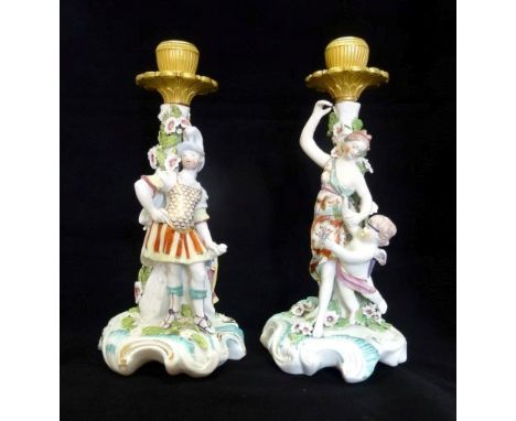 A near matching pair of Derby figural candlesticks, modelled as Venus & Cupid and Mars, circa 1765, each on rococo-style base