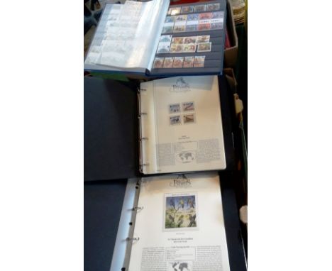 Two boxes containing a large quantity of used and unused GB and all world stamps, together with four albums of Birds of the W