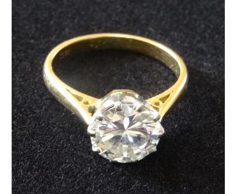 A 18ct yellow and white gold claw mounted round solitaire ring, set with one round brilliant cut diamond, weighing approx. 2 