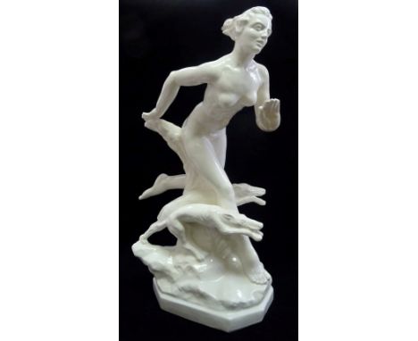 An imposing Art Deco ceramic figure of a nude lady in motion, with two running greyhounds at her feet, 55cm.