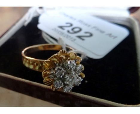 A 18ct gold diamond cluster ring of pierced and floral design.