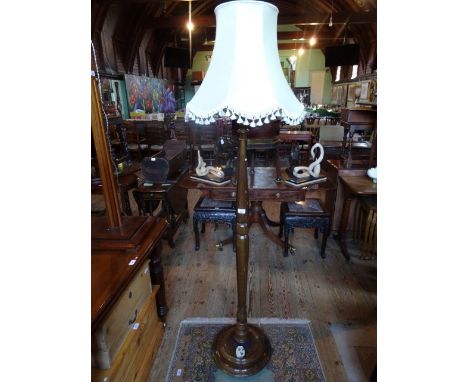 An early 20th century mahogany standard lamp on circular base.