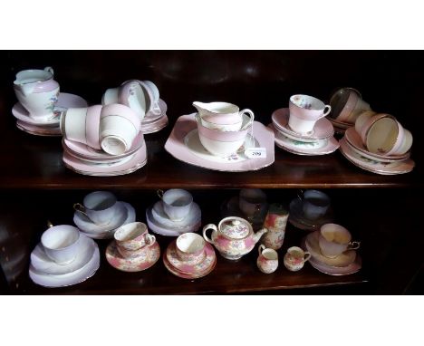 An early 20th century Mintons pink Cockatrice part-tea service comprising: teapot, water jug, cream jug, cups and saucers, to
