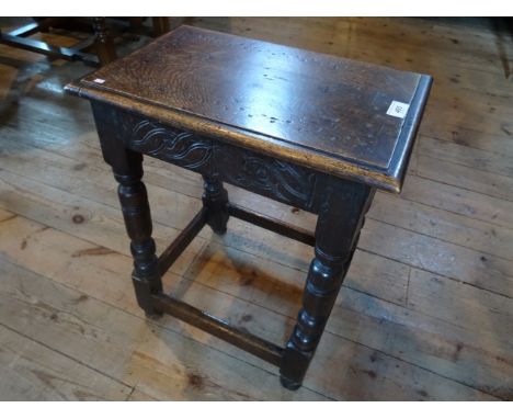 A 19th century and later joint stool with carved decoration on turned supports.