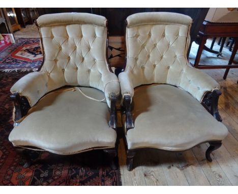 A pair of Victorian mahogany button upholstered salon armchairs.