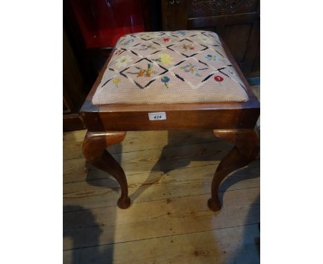 A tapestry upholstered oak piano stool with cabriole legs.