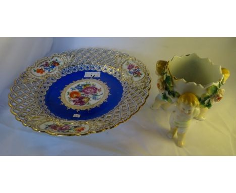 A 20th century Meissen circular dish, the central panel decorated with painted flowers in a gilt and blue well, surrounded by