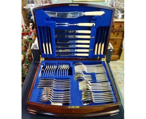 A mahogany canteen of cutlery, a six place setting, including a carving knife and fork.