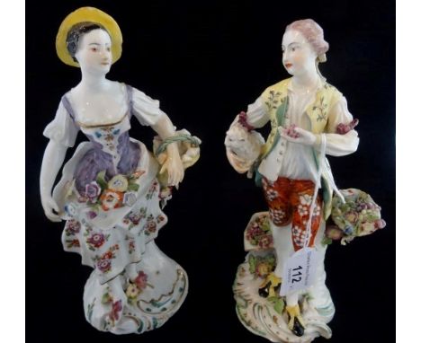 A pair of late 18th century figures, a lady carrying a basket with applied flower decoration, the gentleman holding a lamb un