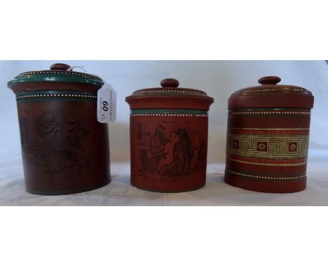 A collection of three 19th century terracotta tobacco jars and covers, possibly by Christopher Dresser, the first decorated a