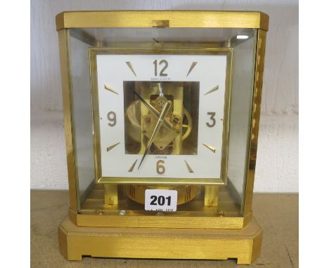 A 1950s Jaeger LeCoultre brass Atmos clock on square form on a plinth base A/F