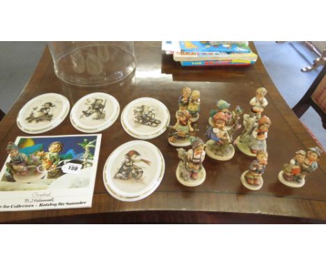A collection of Goebel figures with four Goebel plates