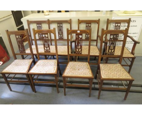 An Edwardian mahogany inlaid salon suite comprising sofa, two armchairs and four side chairs