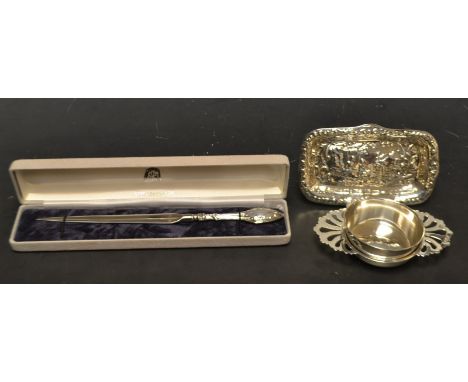 A silver trinket tray, embossed with figures and scrolls,  Sheffield 1981; a silver tea strainer and stand, London 1975; a st