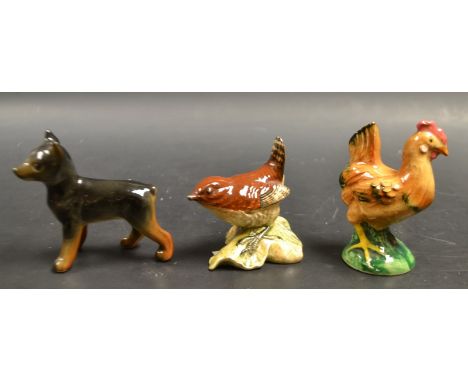 A Beswick figure of a wren; a Goebel figure of a dog; another of a chicken (3)
